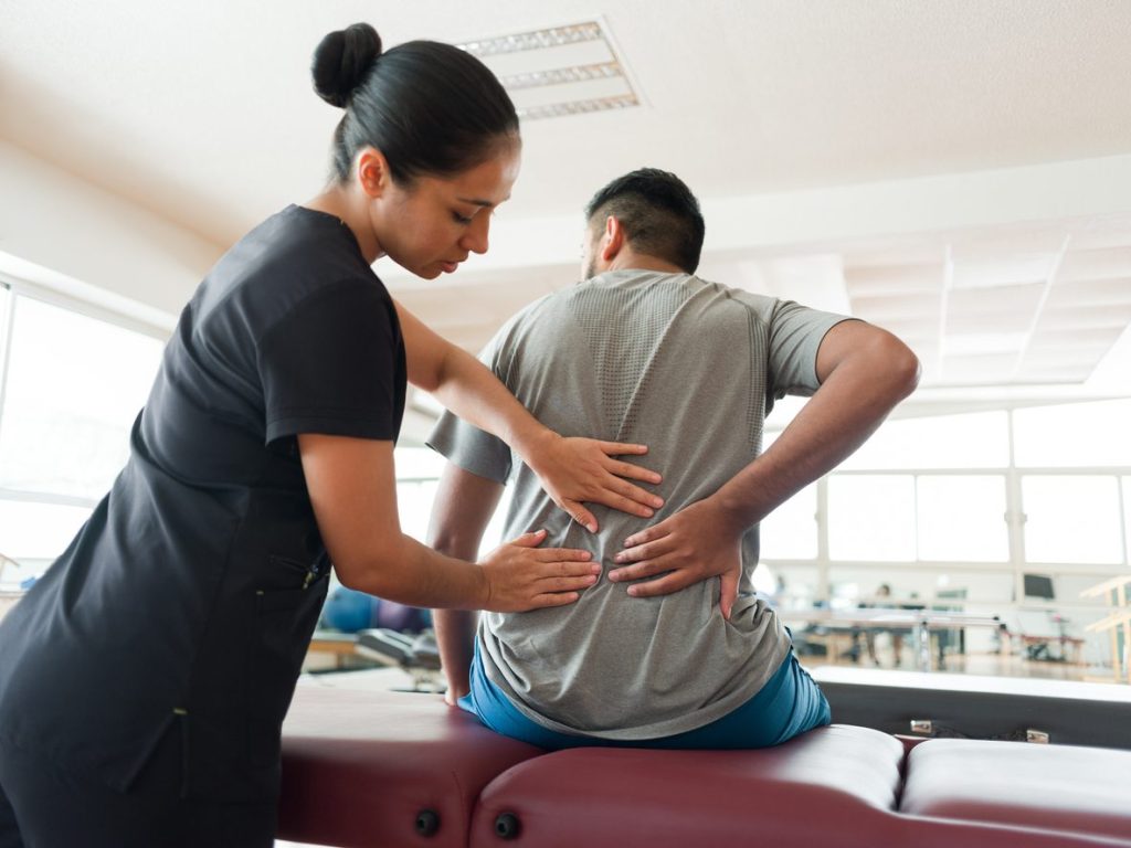 Physical therapist treating lower back pain